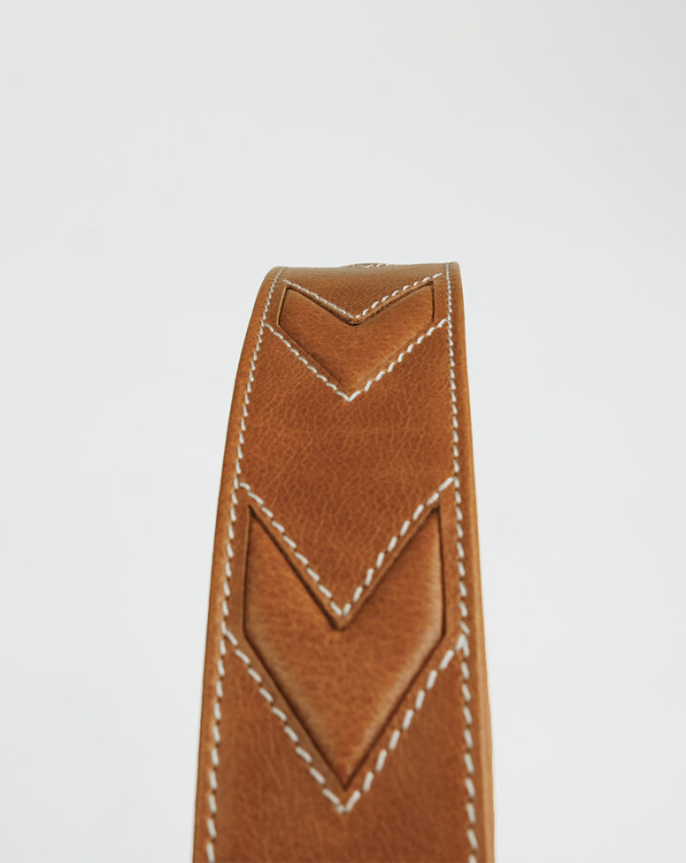 The Arrow, MakladWali's genuine leather take on the barrel bag, gets its name from the arrow-shaped stitching on its strap.