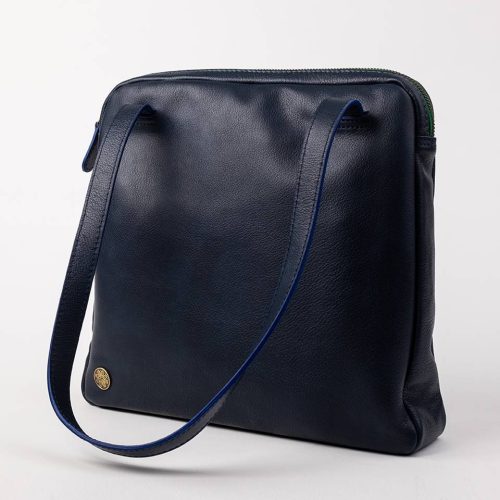 The Baby Jud is a genuine leather handbag with a colored brass zipper.